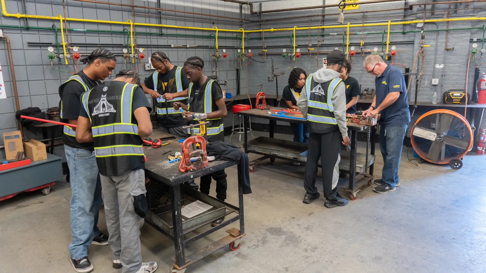 Bridge 2 Trades students practicing hands-on trade skills in a workshop